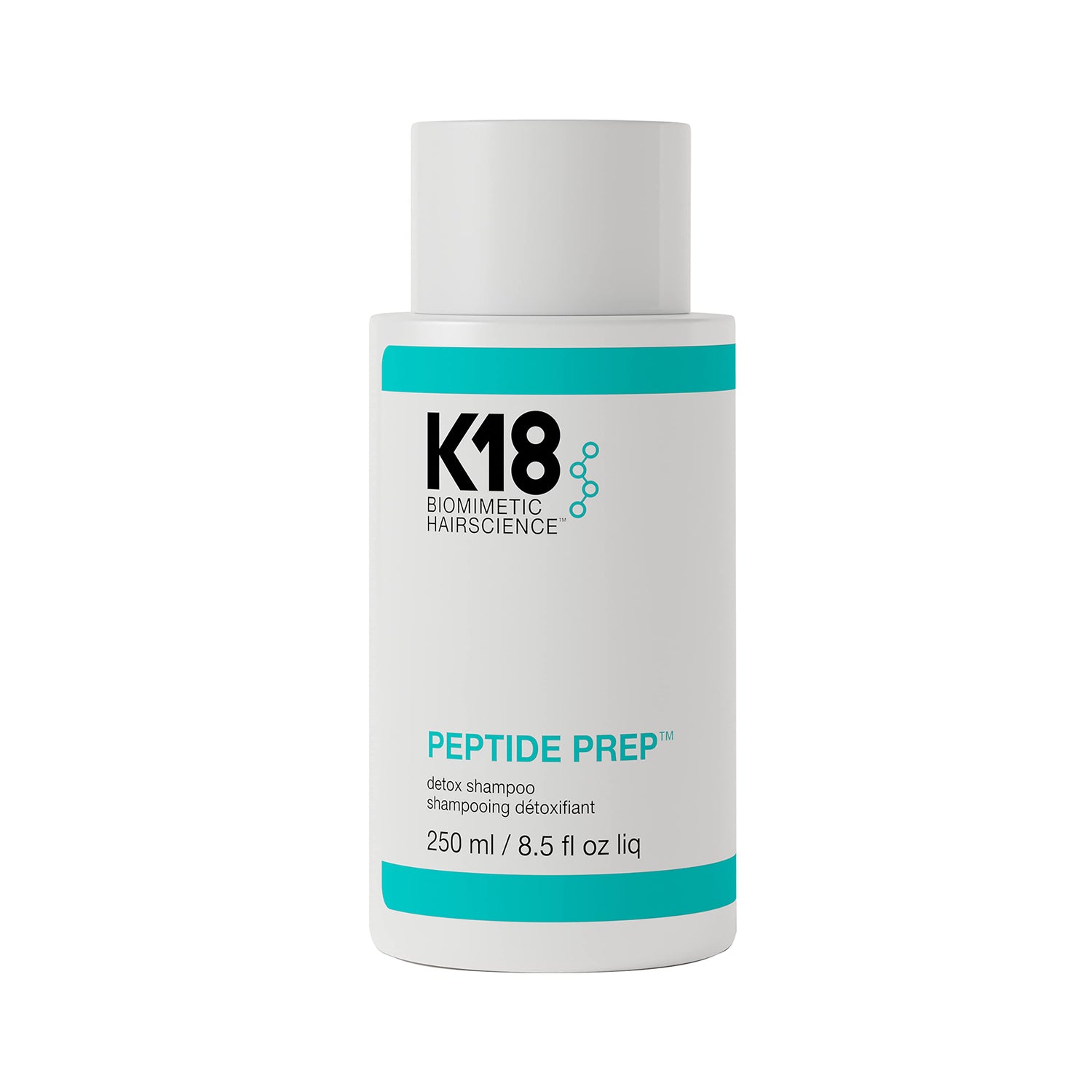 A bottle of K18 Peptide Prep Shampoo with a white and teal label, displaying the brand name and product details.